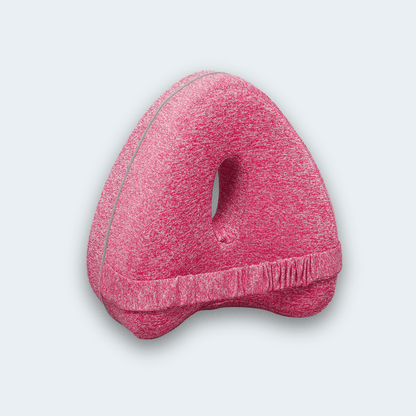 KneeFit knee pillow in pink with elastic strap and central cut-out