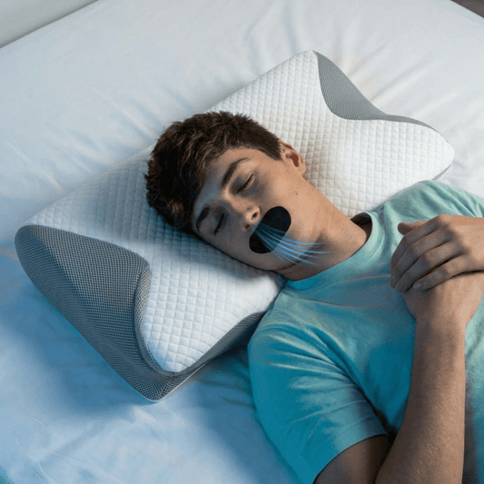Young man sleeping on a pillow with his mouth open