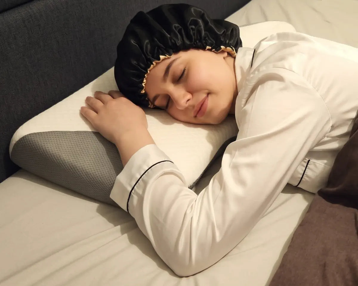 The same person lying on their stomach, the head resting on the flatter side of the pillow.